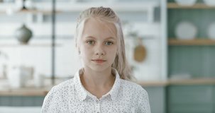 FIXED Portrait of little cute Caucasian girl looking and smiling into camera. 60 FPS Slow Motion, 4K RAW graded footage
