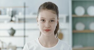 FIXED Portrait of little cute Caucasian girl doing silly funny face, looking into camera. 60 FPS Slow Motion, 4K RAW graded footage