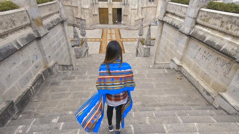 Girl running down steps of the Basílica del Voto Nacional, one the largest neo-Gothic church found in the Historic Centre of Quito, Ecuador