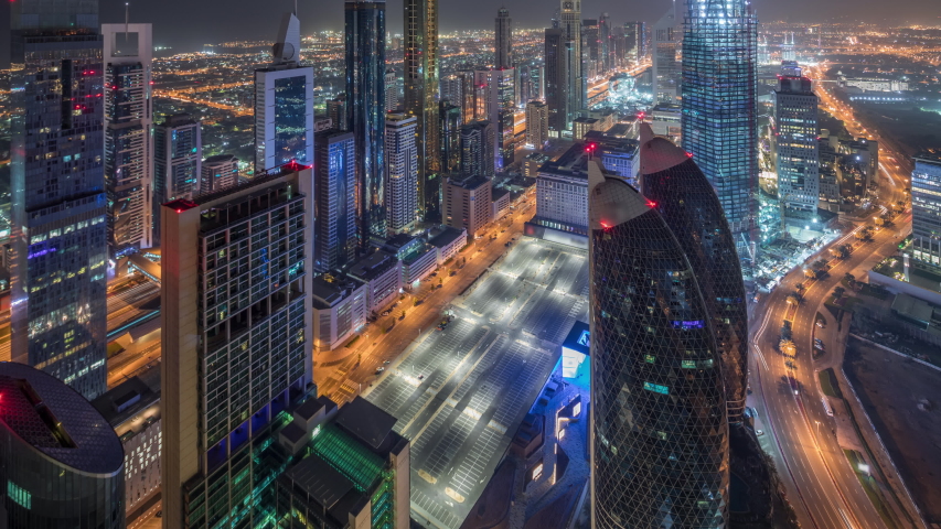 Skyline of the buildings near Sheikh Zayed Road and DIFC aerial day to night transition timelapse in Dubai, UAE. Modern towers and skyscrapers in financial center and downtown after sunset | Shutterstock HD Video #1034785859
