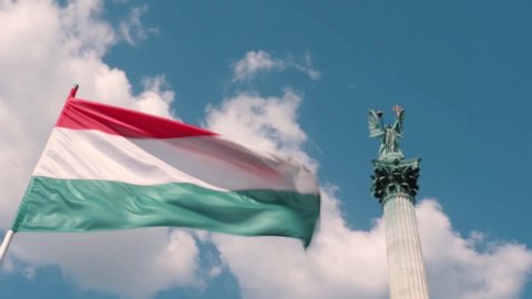 Flag of Hungary swaying in the wind on the heroes square in Budapest dedicated to the Millennium of the Hungarians homeland