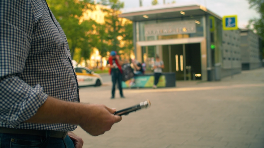 Hands of a criminal playing with a knife in the city