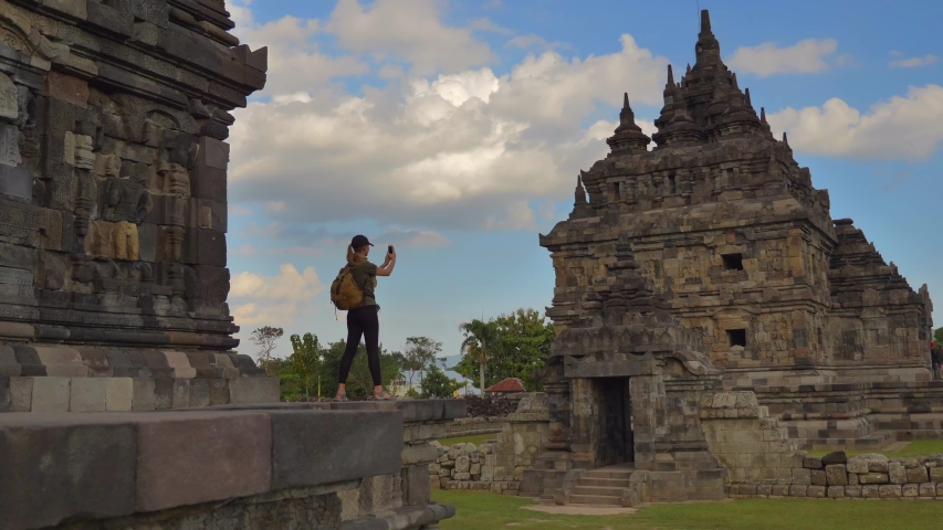 Tourist meets take mobile photo at Plaosan temple in Java island,Indonesia, static handled shot