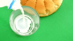 Top view milk poring on green background