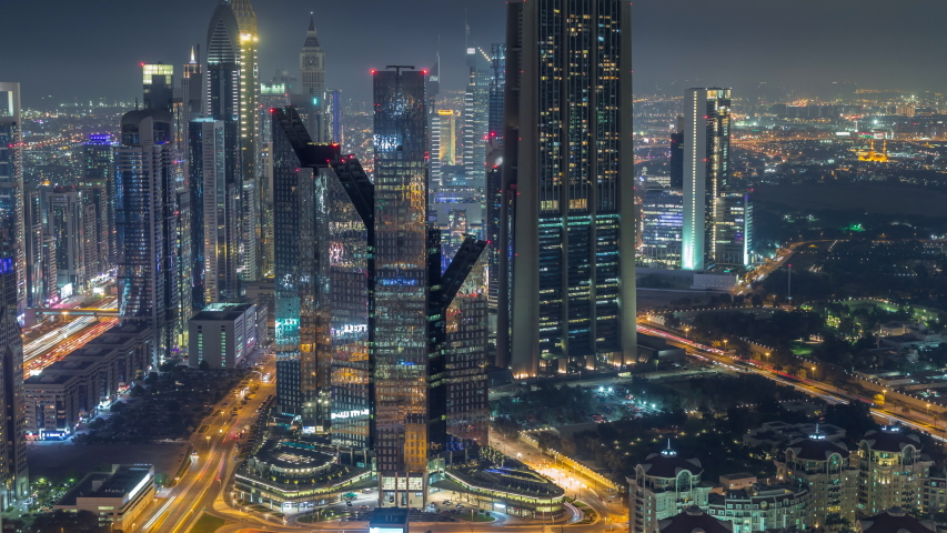 Dubai International Financial Centre district with illuminated modern skyscrapers night timelapse. Aerial view from Downtown with traffic on streets | Shutterstock HD Video #1034808776