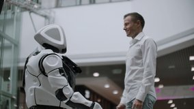 Interaction of man and modern technologies of artificial intelligence. Close up male hand of scientist shakes robotic arm. Robotic and human hands join in a handshake. Meeting and greeting friends - Powered by Shutterstock - Get 15% off with code: PIKWIZARD15