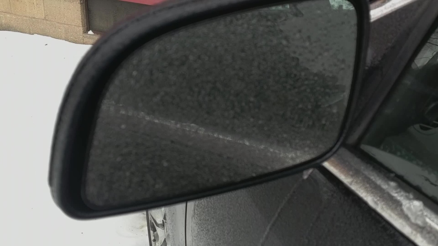 pan shot of ice on car mirror