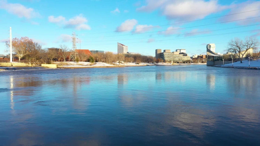 Aerial video of the Keeper of the Plains footbridge near downtown Wichita, Kansas near sunset.