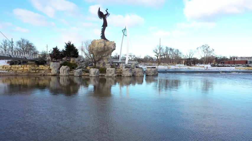Aerial video during winter at the Keeper of the Plains near downtown Wichita, Kansas near sunset.