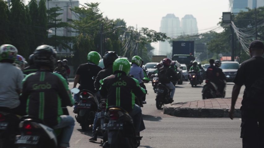 Busy street scene in Jakarta, Lots of motorbikes travelling down a road Royalty-Free Stock Footage #1034816702