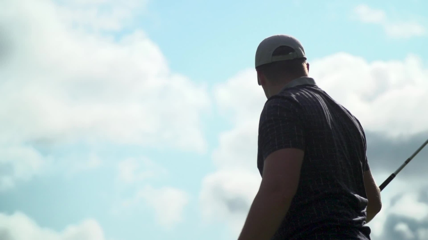 London , Ontario / Canada - 05 02 2019: Golfer in white hat and checkered shirt watching golf shot after taking swing. | Shutterstock HD Video #1034818847