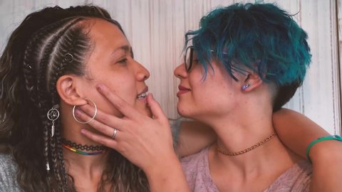 Slow motion tender kiss between young lesbian couple. Long and short hair. Hot kiss between girlfriends. Love last forever. Proud to be gay. : vidéo de stock