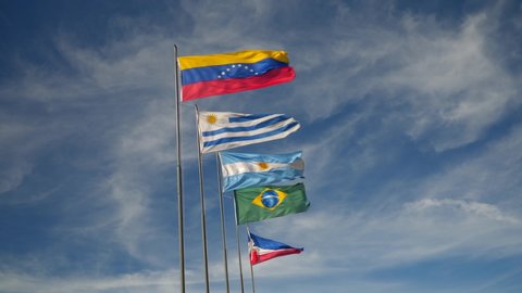 Mercosur Flags Waving on a Sunny Day against Blue Sky. South America Countries, Venezuela, Uruguay, Argentina, Brazil and Paraguay.