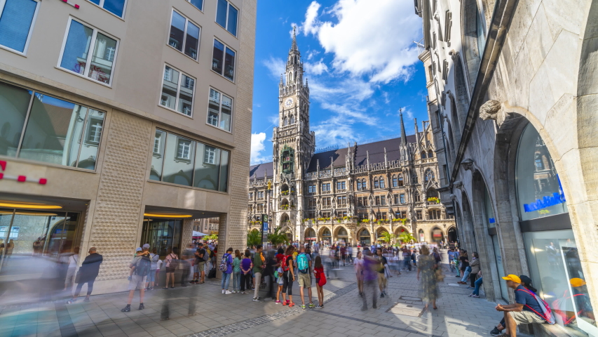 Tourists walking at the Munich Marienplatz street view in front of Town Hall in Germany, marienplatz square is post popular square in Munchen timelapse hyperlapse video.