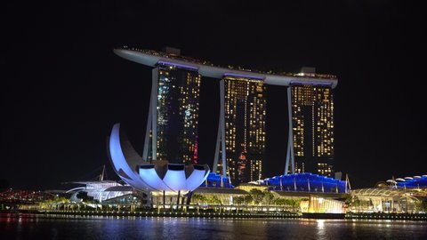 SINGAPORE CITY, SINGAPORE - MARCH 29, 2019: Marina Bay Sands is an integrated resort fronting Marina Bay at night view, establishing shot