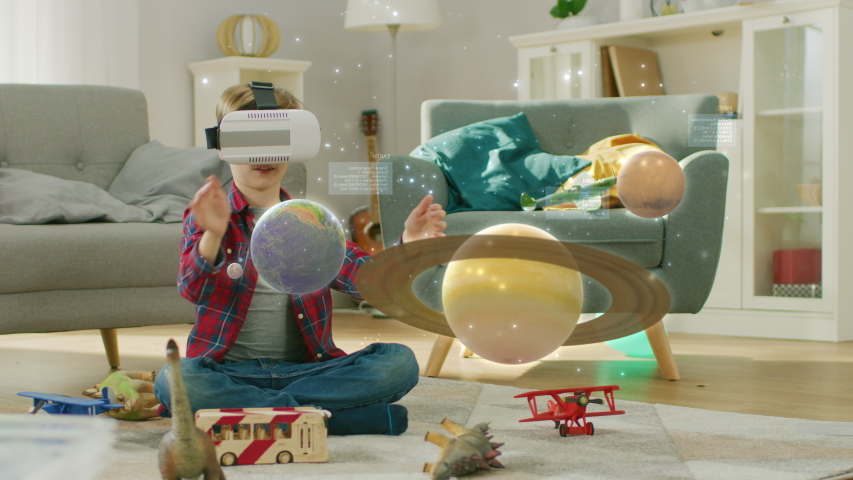 Smart Little Boy Wearing Augmented Reality Headset Plays with Space Learning Software, With Gestures He Manipulates 3D Planets, Discovers Facts About Solar System and Cosmos | Shutterstock HD Video #1034861858