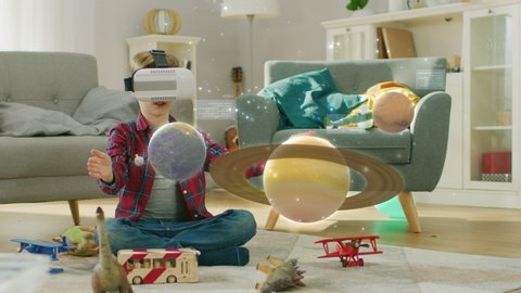 Smart Little Boy Wearing Augmented Reality Headset Plays with Space Learning Software, With Gestures He Manipulates 3D Planets, Discovers Facts About Solar System and Cosmosの動画素材