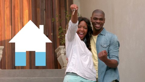 Animation of a happy young adult African American couple seen from the waist up, standing inside their home, the woman waving keys in the air, while an empty icon of a house fills almost to the top