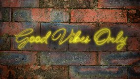 Animation of the words Good Vibes Only in handwriting style flickering yellow neon on a red brick wall background - Powered by Shutterstock - Get 15% off with code: PIKWIZARD15