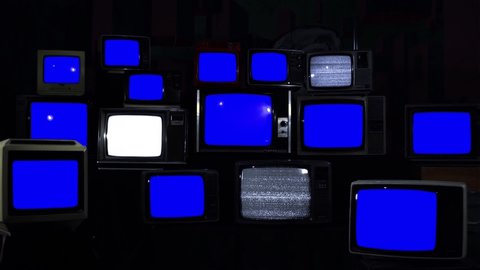 Stacked Vintage TVs turning on and off Blue Screens. Blue Dark Tone.  You can replace blue screen with the footage or picture you want with “Keying” effect in AE (check out tutorials on Internet).
