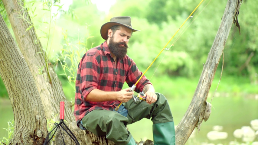Man fisherman catches a fish. Fly fishing. Brown trout being caught in fishing net. American angler fishing. Brown trout fish. Fisherman. Fishes catching hooks