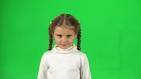 Girl is unsatisfied and shows gesture threatens by shaking her index finger on green screen at studio.