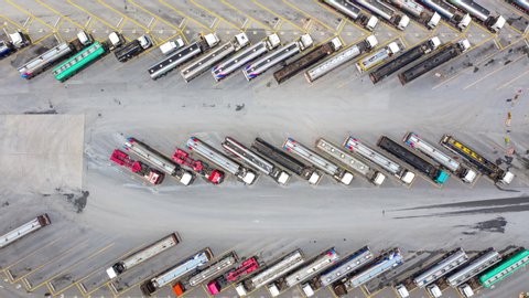 Aerial top view automobile and automotive semi truck cargo trailer car parking with other truck on oil station parking, Business industry factory logistic power and energy fuel petroleum, Time lapse.