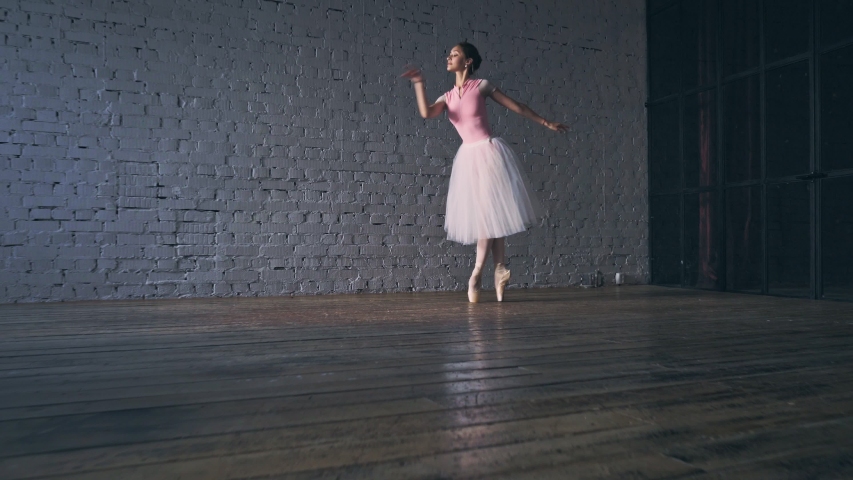 Young ballerina dancing in the hall