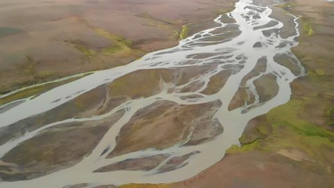 Flying over river delta landscape in Iceland highlands, aerial view