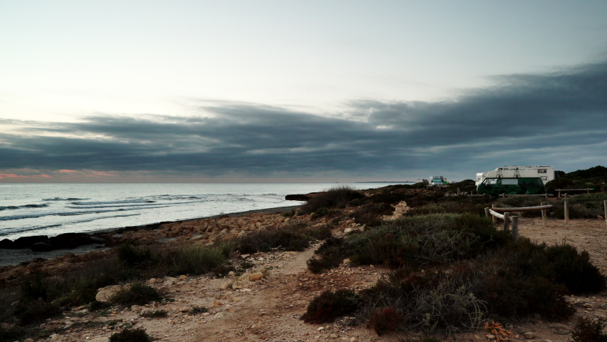 Sea beach, spanish Costa Blanca coastline with camper cars, Spain Alicante province. Time lapse