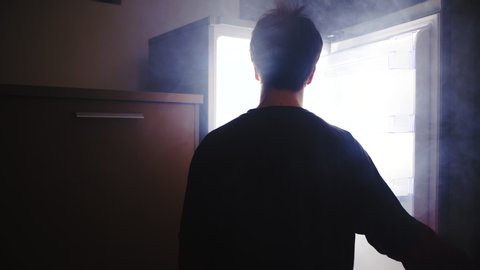 Person open the smoking hot fridge at night 4K