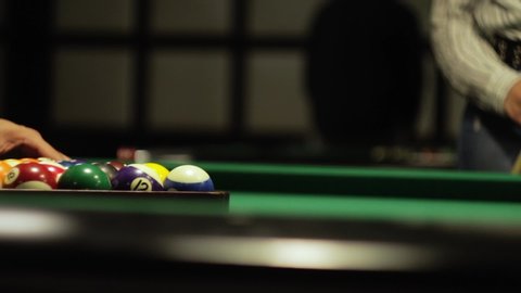marker puts balls on the pool table
