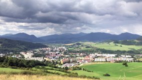 Time-Lapse Video 4K: ?hange from rainy to sunny weather. Dramatic clouds and summer landscape of the city in the mountain, Dolny Kubin, Slovakia.
