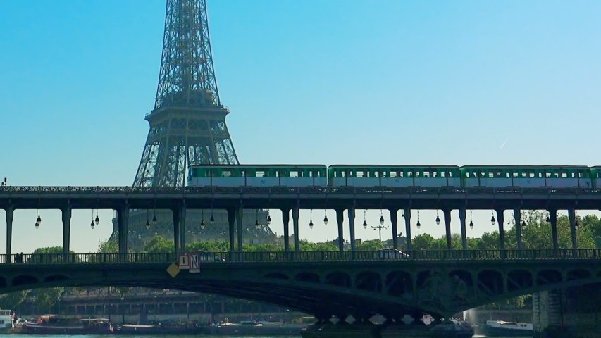 Metro train over Bir-Hakeim bridge and the Eiffel Tower - Paris - France | Shutterstock HD Video #1034912051