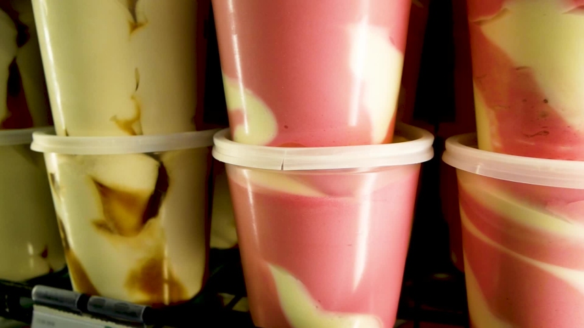 Different types of colourfull ice cream in the fridge close-up