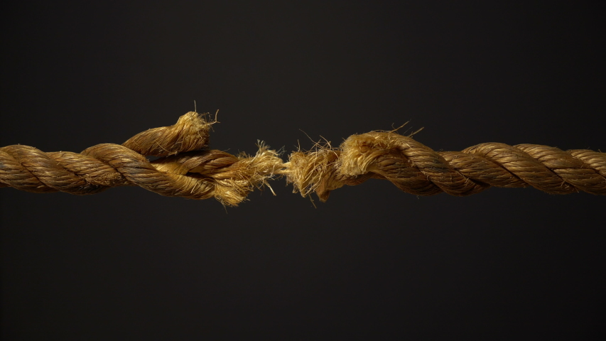 A frayed rope on the verge of snapping under stress | Shutterstock HD Video #1034921414