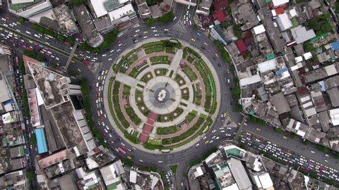 Bangkok, Thailand, top-down aerial view of traffic around huge roundabout during rush hour.