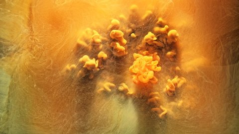 Ink water flow. Magic explosion. Golden colored liquid nitrogen. Yellow acrylic paint motion. Stock Video