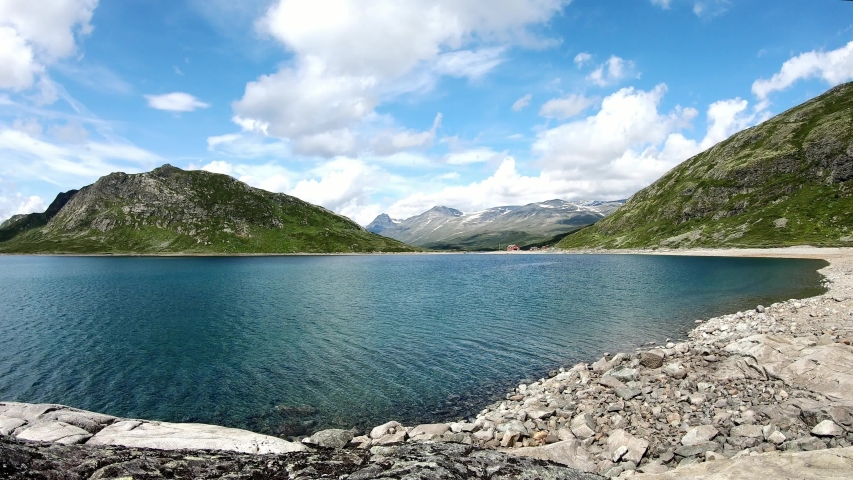 Time Lapse footage. Jotunheimen National park, Norway. View to the beautiful mountain lake in the sunny weather.