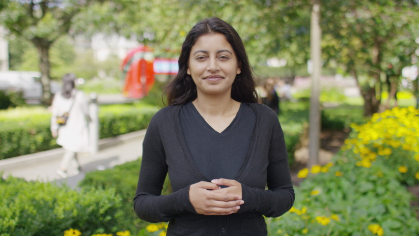 Young Asian female signing to camera and introducing herself