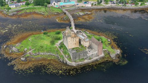 Aerial view of Eilean Donan Castle, medieval castle situated on tidal island on sea Loch Duich - landscape panorama of  Highlands of Scotland from above, Dornie, United Kingdom, Great Britain, Europe