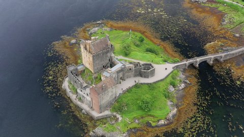 Aerial view of Eilean Donan Castle, medieval castle situated on tidal island on sea Loch Duich - landscape panorama of  Highlands of Scotland from above, Dornie, United Kingdom, Great Britain, Europe