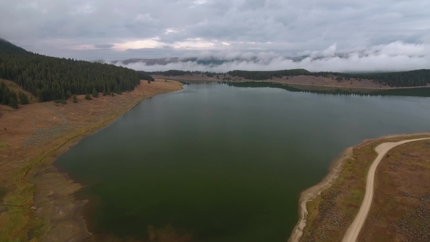 Flying over Meadowlark Lake on cloudy day. Wyoming USA. Aerial