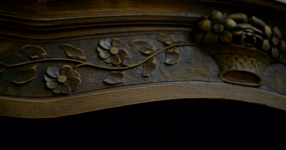 woman is touching decor of old wooden cabinet, close-up of hands