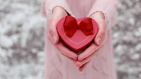 Female hands hold a gift box shaped of heart. The Valentines day and Christmas theme - Powered by Shutterstock - Get 15% off with code: PIKWIZARD15
