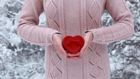 Female hands hold a gift box shaped of heart. The Valentines day and Christmas theme - Powered by Shutterstock - Get 15% off with code: PIKWIZARD15
