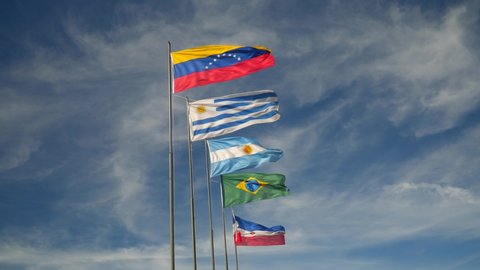 Mercosur Flags Waving on a Sunny Day against Blue Sky. South America Countries, Venezuela, Uruguay, Argentina, Brazil and Paraguay.