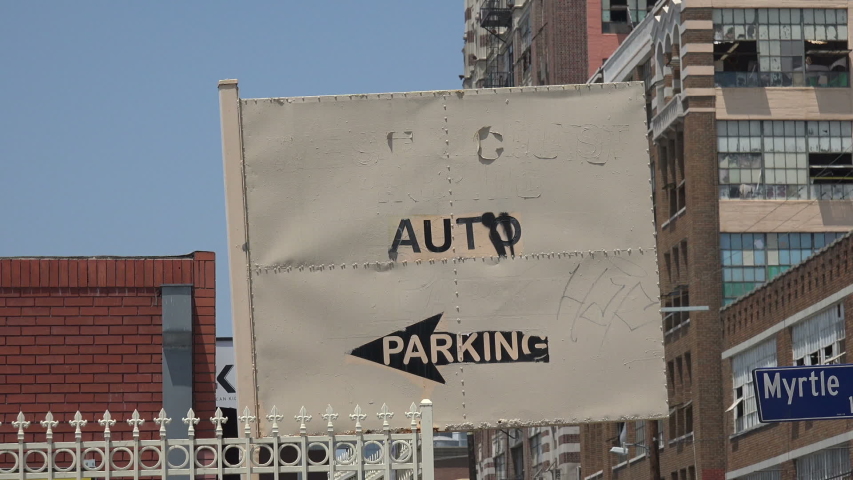 A sign pointing to an auto parking lot