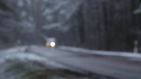 Car driving on winter snow forest road. Focus pull.