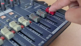 Man adjusting aound an Audio mixer, Working with sound mixing console. - Powered by Shutterstock - Get 15% off with code: PIKWIZARD15